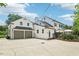 Rear elevation of a charming home with a two-car garage and a brick-paved patio at 1004 E Willowbrook Dr, Burlington, NC 27215