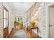 Gracious foyer features beautiful wallpaper, hardwood floors, and staircase at 1004 E Willowbrook Dr, Burlington, NC 27215
