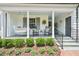 Inviting front porch featuring a porch swing and classic rocking chairs at 1004 E Willowbrook Dr, Burlington, NC 27215