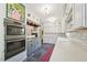 Open kitchen features stainless appliances, sleek countertops and white brick accents at 1004 E Willowbrook Dr, Burlington, NC 27215