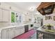 Bright, eat-in kitchen with white cabinets, farmhouse sink, and stainless steel appliances at 1004 E Willowbrook Dr, Burlington, NC 27215