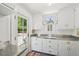 Well-lit kitchen features ample counter space, white cabinetry and stainless steel appliances at 1004 E Willowbrook Dr, Burlington, NC 27215