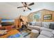 Cozy wood-paneled living room with comfortable seating, modern media console, and exercise equipment at 1004 E Willowbrook Dr, Burlington, NC 27215
