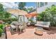 Outdoor patio with comfortable seating, dining set, and charming brick pavers at 1004 E Willowbrook Dr, Burlington, NC 27215