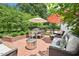 Charming outdoor patio with comfortable seating, dining set, and stylish umbrellas at 1004 E Willowbrook Dr, Burlington, NC 27215