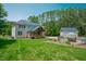 Backyard view of house with solar panels, large deck and the pool at 1005 Hidden River Ct, Raleigh, NC 27614