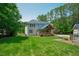Scenic backyard of home featuring a deck, green grass, and solar panels at 1005 Hidden River Ct, Raleigh, NC 27614