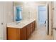Bathroom with double vanity with tile floors with views of the bedroom at 1005 Hidden River Ct, Raleigh, NC 27614