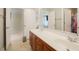 Bathroom with a double vanity, tile floors and a doorway to the main living area at 1005 Hidden River Ct, Raleigh, NC 27614