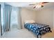 Cozy bedroom with a window, ceiling fan, and blue floral bedding at 1005 Hidden River Ct, Raleigh, NC 27614