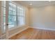 Bright and airy bedroom features hardwood floors, crown molding, and a large window at 1005 Hidden River Ct, Raleigh, NC 27614
