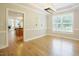 Bright dining room features hardwood floors and is connected to a modern kitchen at 1005 Hidden River Ct, Raleigh, NC 27614