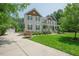 Well-maintained home with a manicured lawn, complemented by an oversized driveway leading to a detached garage at 1005 Hidden River Ct, Raleigh, NC 27614