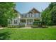 Charming two-story home with inviting front porch and meticulously landscaped lawn at 1005 Hidden River Ct, Raleigh, NC 27614