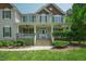 Inviting front porch with classic white columns and meticulous landscaping enhances curb appeal at 1005 Hidden River Ct, Raleigh, NC 27614