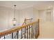 Hallway with a decorative light fixture and staircase leading to a bright open space at 1005 Hidden River Ct, Raleigh, NC 27614