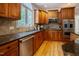 This contemporary kitchen has beautiful wood cabinets and granite countertops with a tile backsplash at 1005 Hidden River Ct, Raleigh, NC 27614