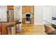 Kitchen with an island, granite countertops, a workspace and adjacent to another room at 1005 Hidden River Ct, Raleigh, NC 27614