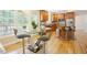 Open concept kitchen with bar stool seating at the island and eating area with a glass table set at 1005 Hidden River Ct, Raleigh, NC 27614