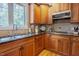 Updated kitchen with stainless appliances, wood cabinets, stone backsplash, and granite countertops at 1005 Hidden River Ct, Raleigh, NC 27614