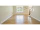 Bright living room with hardwood floors, large window, and elegant staircase at 1005 Hidden River Ct, Raleigh, NC 27614