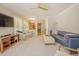 Spacious living room featuring plush seating, a ceiling fan, and open access to the kitchen at 1005 Hidden River Ct, Raleigh, NC 27614