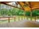 A view of the covered porch with a ceiling fan and backyard scenery at 1005 Hidden River Ct, Raleigh, NC 27614