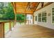 View of the covered porch with wood flooring, white posts, and a ceiling fan at 1005 Hidden River Ct, Raleigh, NC 27614