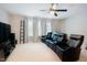 Home theater room features comfortable leather seating, a ceiling fan, and space for entertainment at 1005 Hidden River Ct, Raleigh, NC 27614
