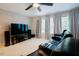 Home theater space with black leather seating, a large screen, and speaker setup for immersive entertainment at 1005 Hidden River Ct, Raleigh, NC 27614
