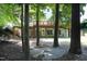 Charming backyard view with a stone patio and trees, leading up to a raised deck with railings at 101 Royal Glen Dr, Cary, NC 27518