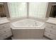 Bright bathroom with corner soaking tub, decorative tile, and and sinks at 101 Royal Glen Dr, Cary, NC 27518