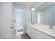 Well-lit bathroom with double sink vanity, large mirror, and a view into the adjacent shower area at 101 Royal Glen Dr, Cary, NC 27518