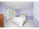 Charming bedroom with purple walls, a plush bed, a ceiling fan, and a window for natural light at 101 Royal Glen Dr, Cary, NC 27518