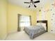 Comfortable bedroom with a ceiling fan, yellow walls, and a bed with a light gray comforter at 101 Royal Glen Dr, Cary, NC 27518