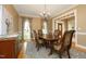 Elegant dining room with chandelier, hardwood floors, and large windows for ample natural light at 101 Royal Glen Dr, Cary, NC 27518