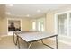 Spacious game room with a ping pong table and a view into a comfortable living space at 101 Royal Glen Dr, Cary, NC 27518