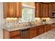 The kitchen features wood cabinets, granite countertops, and stainless steel appliances at 101 Royal Glen Dr, Cary, NC 27518