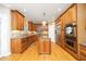 Spacious kitchen features wood cabinets, stainless steel appliances, granite countertops, and a central island at 101 Royal Glen Dr, Cary, NC 27518