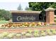Cambridge at Regency community sign with brick base and colorful floral landscaping at 101 Royal Glen Dr, Cary, NC 27518