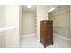 Bright walk-in closet with white shelving, beige carpet, and a dark wood chest of drawers for ample storage at 101 Royal Glen Dr, Cary, NC 27518