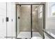 Modern bathroom features a glass-enclosed shower with neutral tiles and a built-in niche at 103 Goldenrod Loop, Clayton, NC 27520