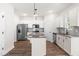 Bright kitchen features stainless steel appliances, granite counters, and a functional island at 103 Goldenrod Loop, Clayton, NC 27520