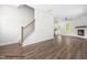 Open concept living room featuring a wooden staircase, hardwood floors, and a fireplace at 103 Goldenrod Loop, Clayton, NC 27520