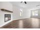Spacious living room with hardwood floors, a modern fireplace, and natural light at 103 Goldenrod Loop, Clayton, NC 27520