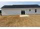 Spacious backyard with sliding glass doors leading to the patio at 1036 Turlington Rd, Dunn, NC 28334