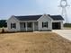 Charming single-story home with a two-car garage and manicured front lawn at 1036 Turlington Rd, Dunn, NC 28334