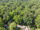 Overhead shot showcasing a neighborhood surrounded by lush forest; the property features a green and private location at 107 Wimbledon Ct, Cary, NC 27511