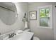 Well-lit bathroom featuring a vanity, toilet, and a window at 107 Wimbledon Ct, Cary, NC 27511