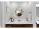 Stylish bathroom featuring dark wood vanity, mirror and white countertop at 107 Wimbledon Ct, Cary, NC 27511